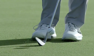 player-practicing-with-a-pitching-wedge