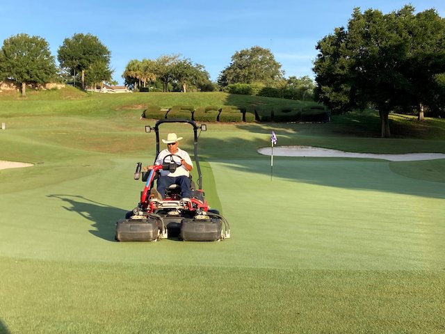 man-overseeding-the-green-on-a-golf-course